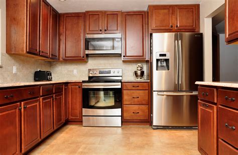 kitchen with wood cabinets and stainless steel appliances|kitchen cabinets with wooden storage doors.